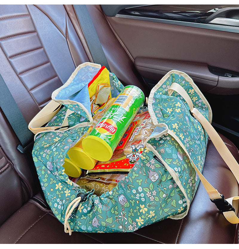Green car back seat organizer hammock made of durable polyester holding travel essentials and travel essentials — view 3