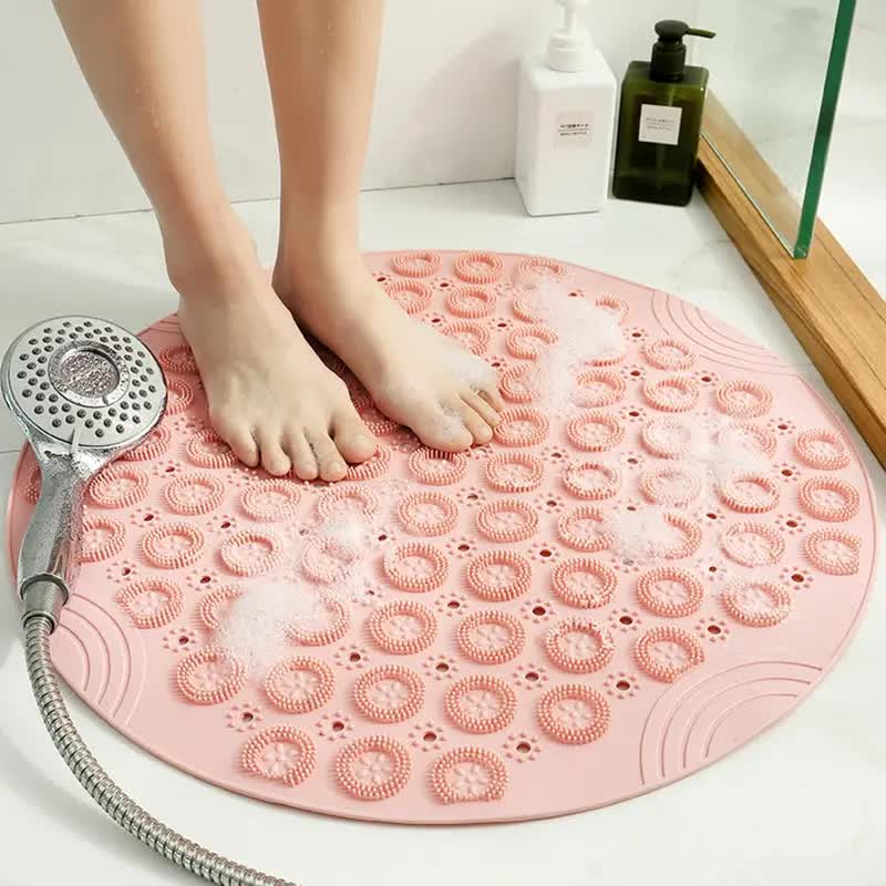 Pink round silicone foot scrubber mat with soft massage bristles for shower floors and bathtubs