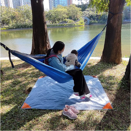 Green and grey waterproof portable camping mat folded out for outdoor picnic and beach use — view 4