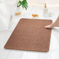 Brown loofah bath mat with textured PVC surface and non-slip backing for safe shower use.