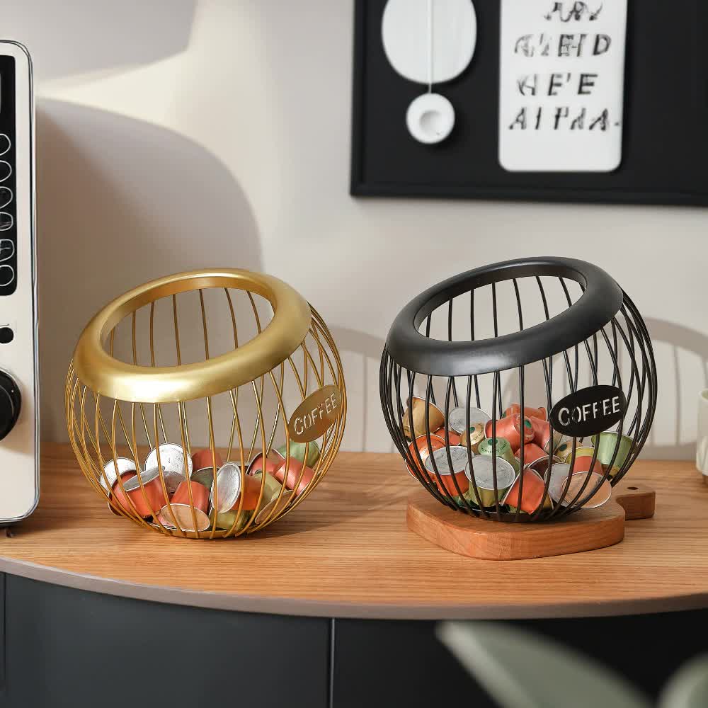 Black handcrafted vintage iron coffee capsule storage basket holding pods on a kitchen countertop — view 2