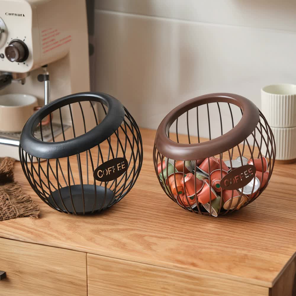 Black handcrafted vintage iron coffee capsule storage basket holding pods on a kitchen countertop — view 3
