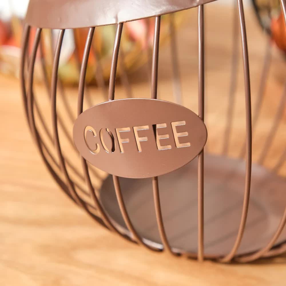 Black handcrafted vintage iron coffee capsule storage basket holding pods on a kitchen countertop — view 5