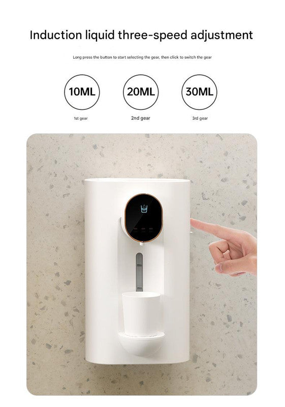 White smart automatic mouthwash dispenser with magnetic cups attached, mounted on a bathroom wall. — view 3