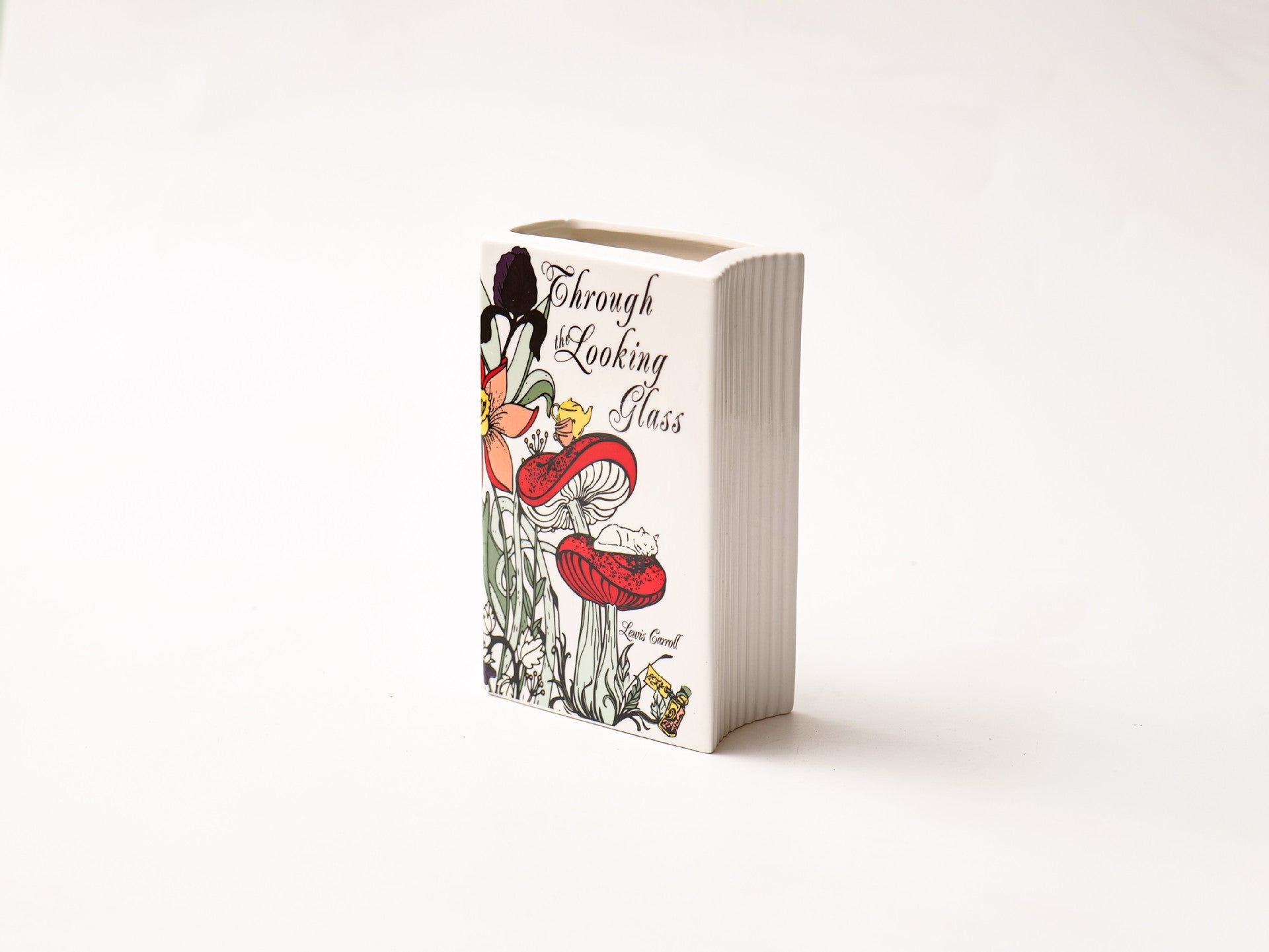 Glazed ceramic book-shaped vase and desk organizer featuring colorful botanical cover illustrations