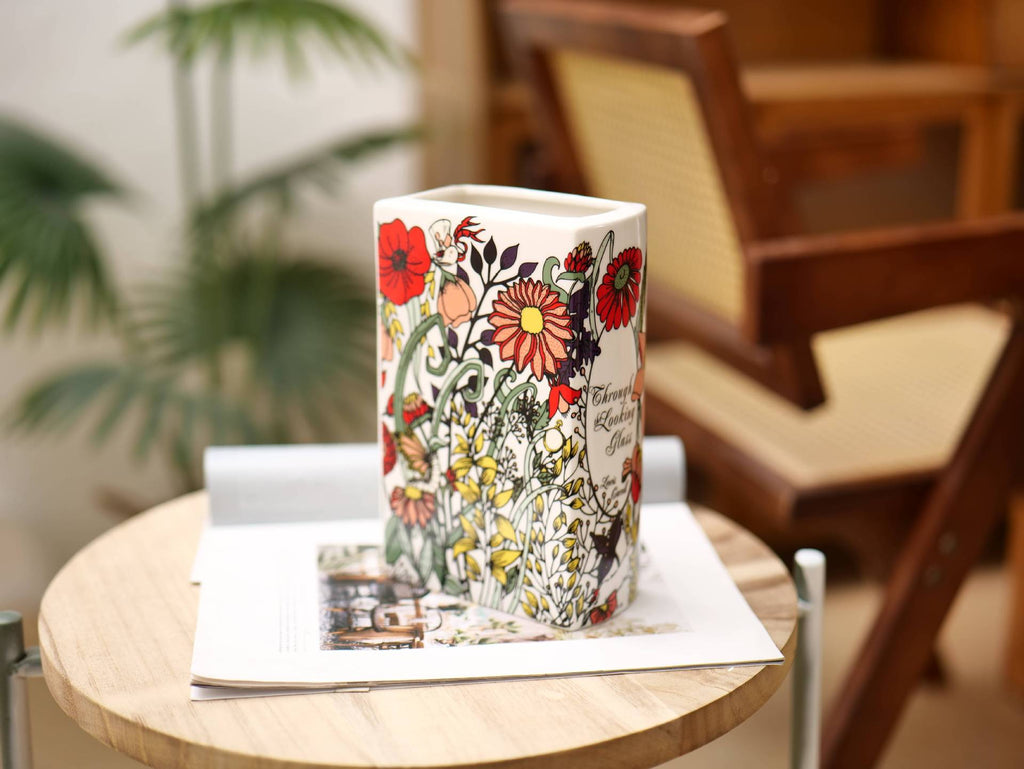 Glazed ceramic book-shaped vase and desk organizer featuring colorful botanical cover illustrations — view 4