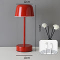 Red minimalist LED table lamp with touch control base, cordless design, and modern aesthetic