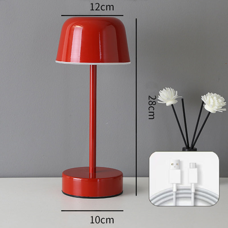 Red minimalist LED table lamp with touch control base, cordless design, and modern aesthetic