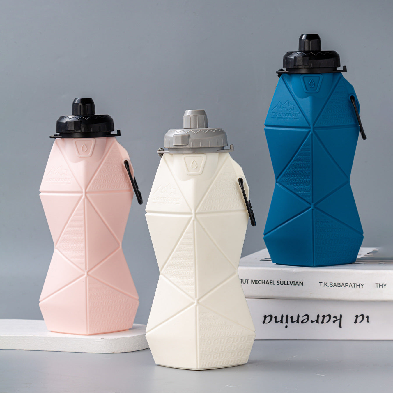 Pink and black foldable silicone water bottle with leakproof lid and convenient retaining strap — view 2