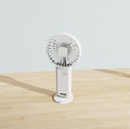 Two white portable mini handheld fans with desktop base and integrated phone stand