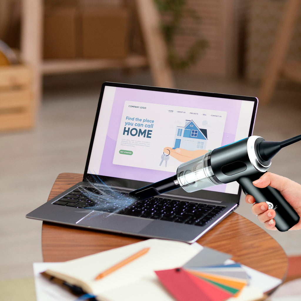 Compact 2-in-1 mini wireless vacuum cleaner and air duster resting on a clean office desk — view 3