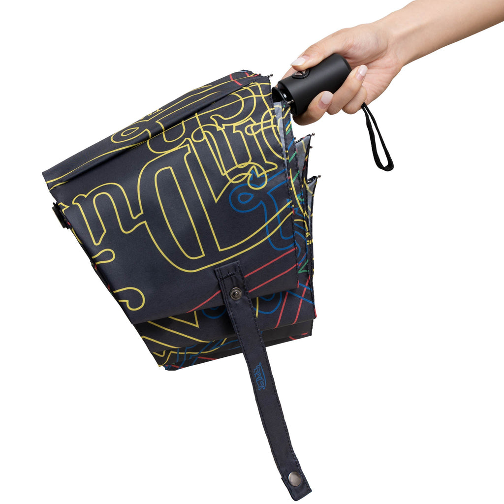 Compact automatic travel umbrella with bold neon graphic print, ergonomic handle, and matching protective sleeve — view 4