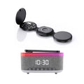 Black folding wireless charging station next to a multifunctional digital bedside alarm clock with speaker