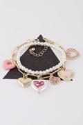Women's heart charm bracelet in gold and silver cream, lightweight stackable romantic jewelry design.