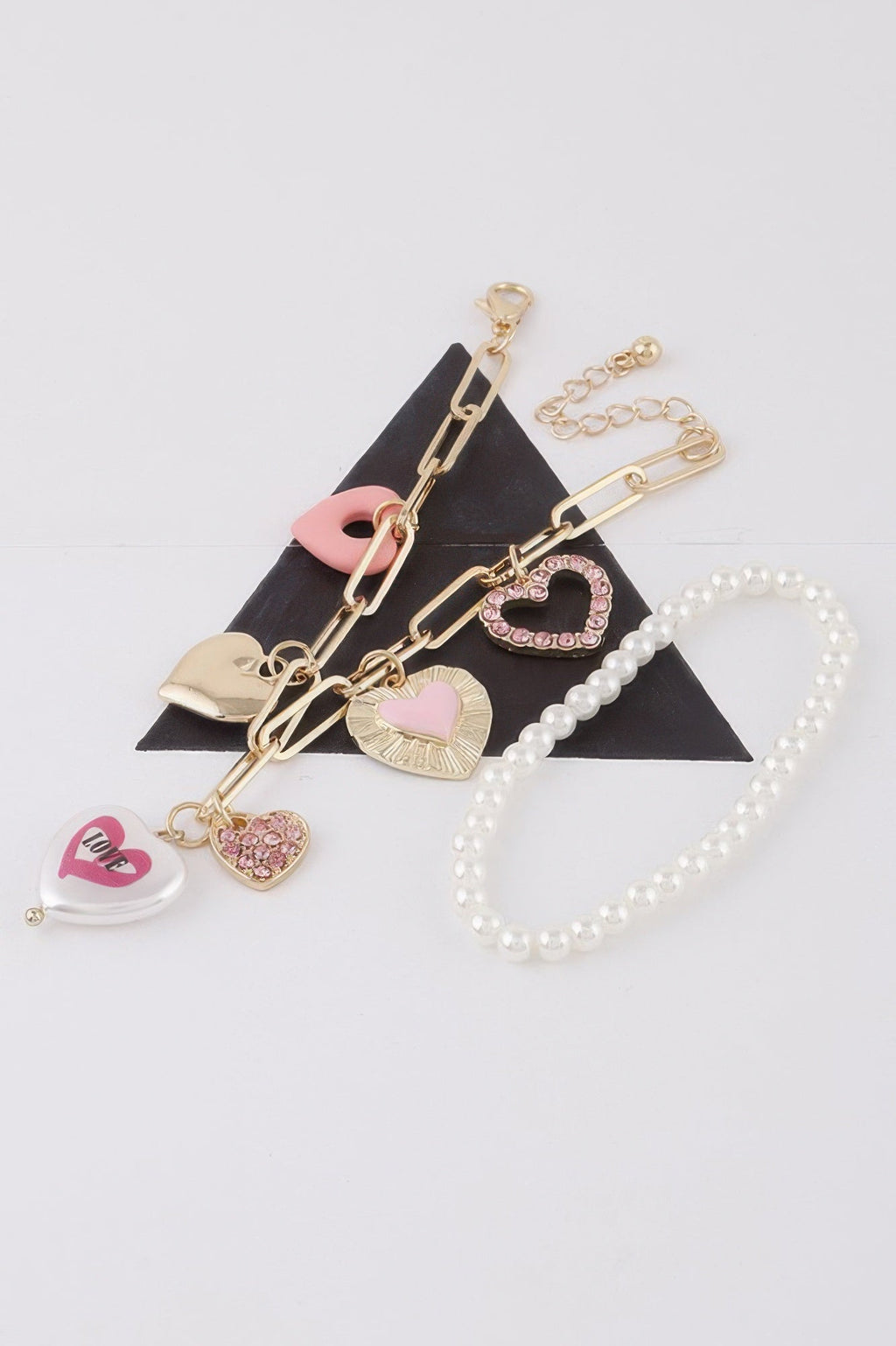 Women's heart charm bracelet in gold and silver cream, lightweight stackable romantic jewelry design. — view 2