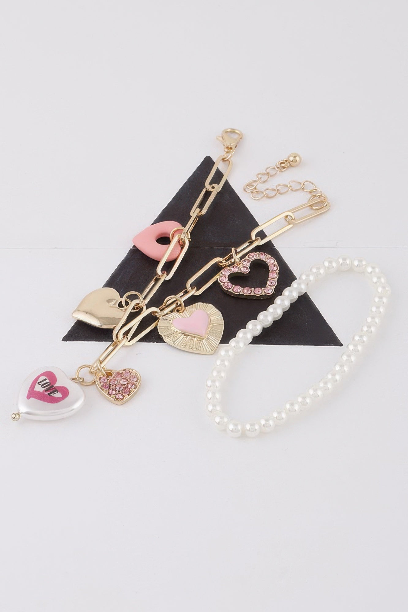 Women's heart charm bracelet in gold and silver cream, lightweight stackable romantic jewelry design. — view 2