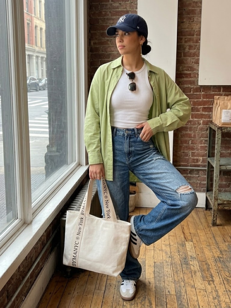 Cream canvas tote bag with black logo typography on reinforced shoulder straps — view 2
