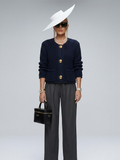Navy blue chunky knit women's jacket featuring oversized gold buttons and a structured elegant silhouette