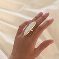 Astor geometric statement ring in marbled white acetate with an adjustable gold-tone band