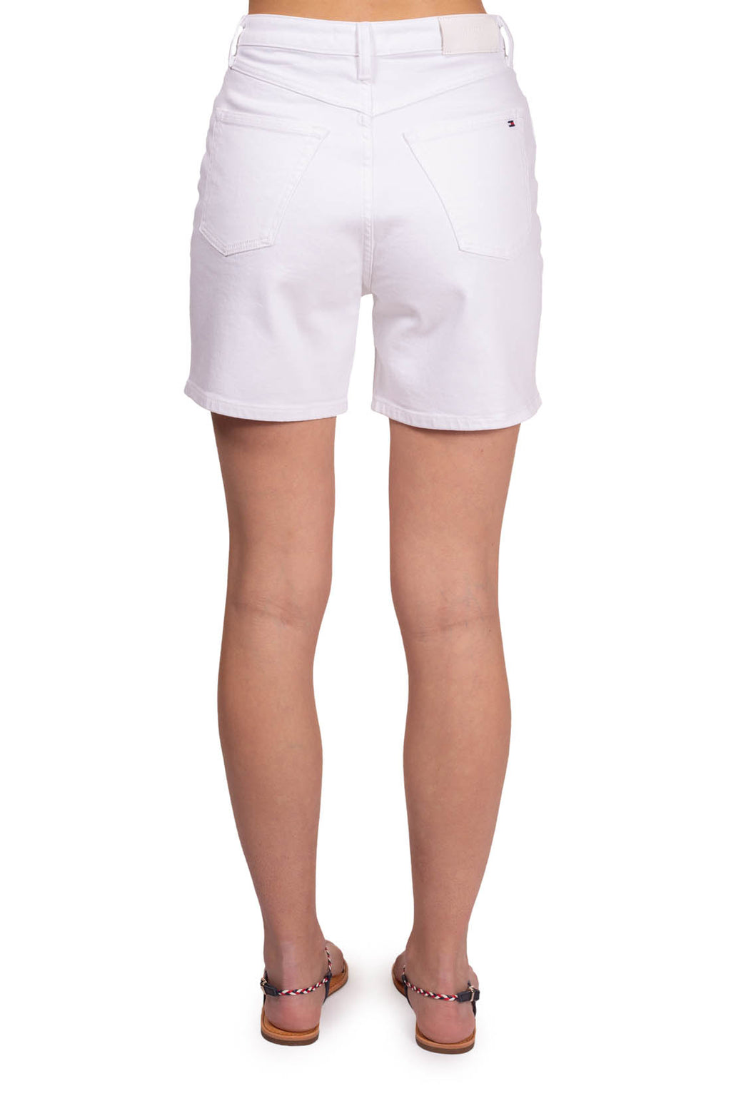 Women's white stretch denim straight shorts with five pockets and button fly on model — view 3