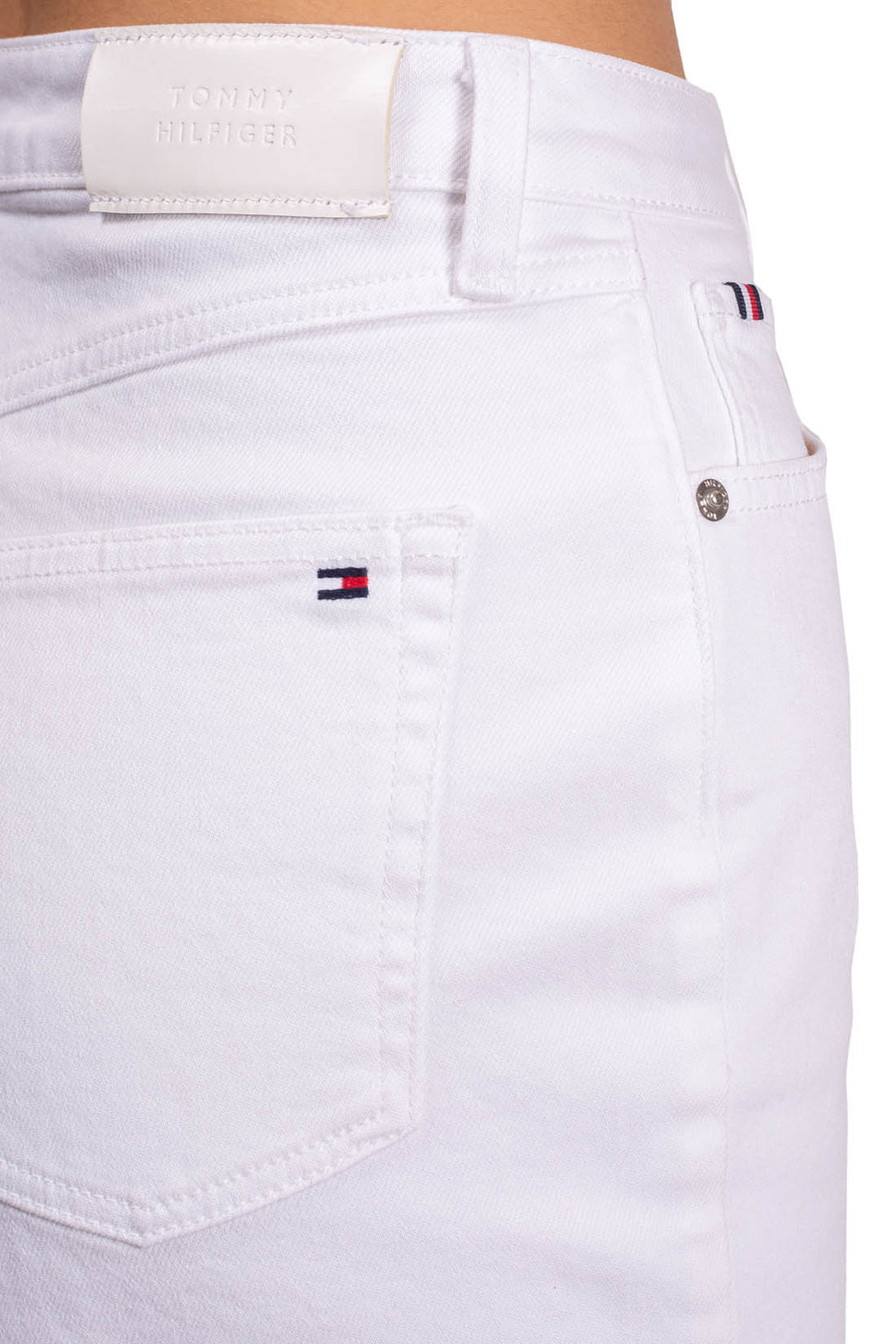 Women's white stretch denim straight shorts with five pockets and button fly on model — view 9