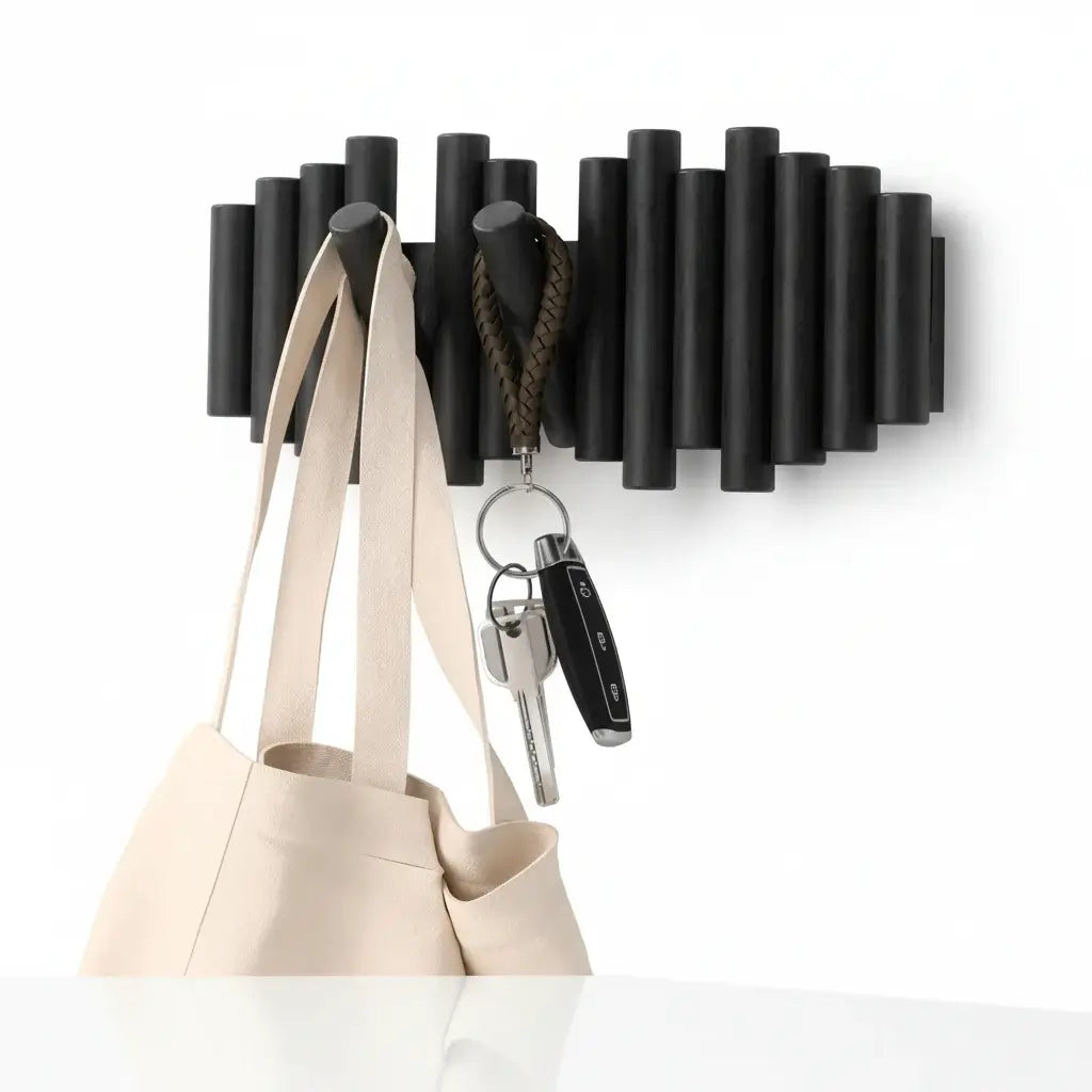 Black wall-mounted pine wood coat rack with five retractable wooden pegs for entryway storage