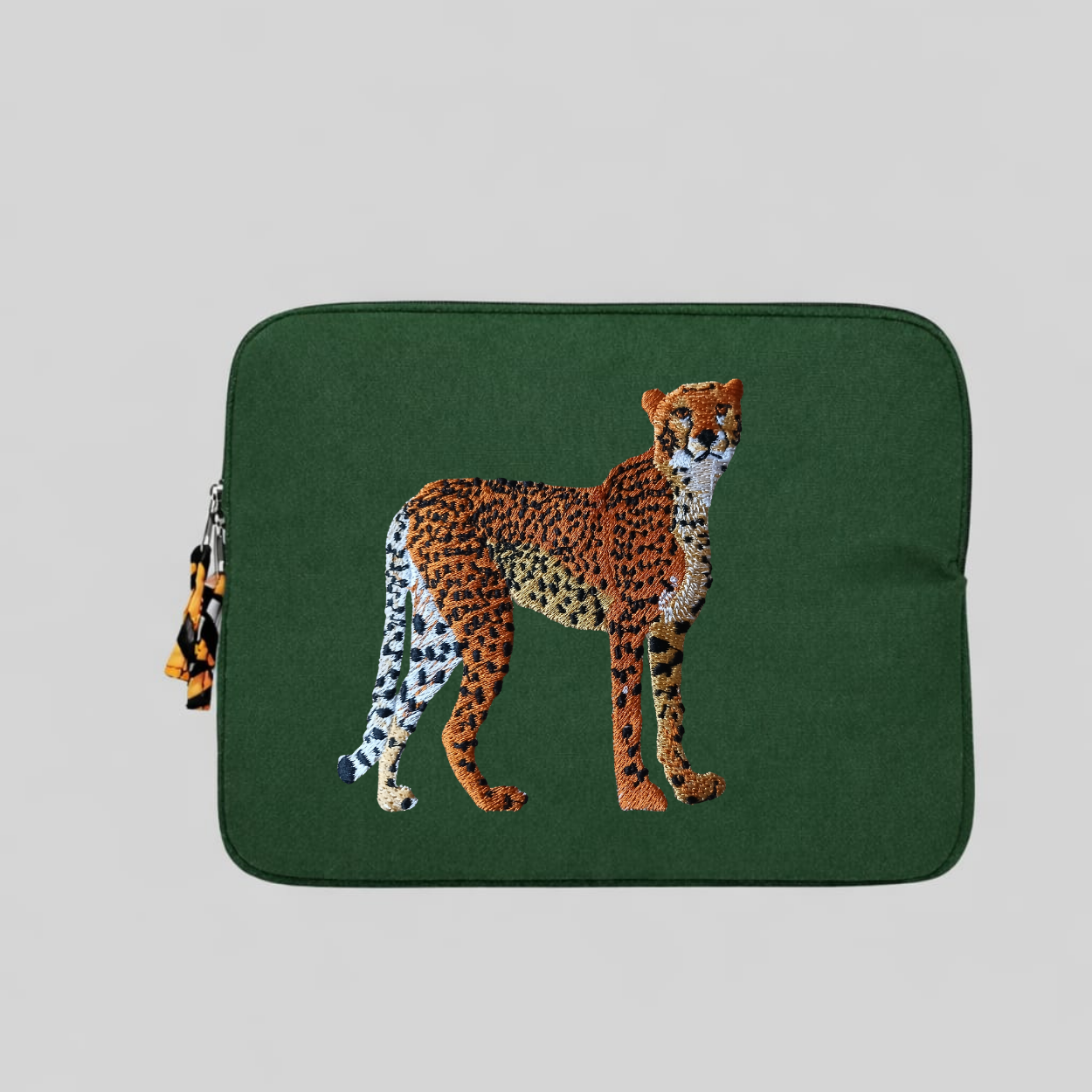 Handmade cotton canvas cheetah laptop sleeve in warm earthy tones featuring detailed animal embroidery