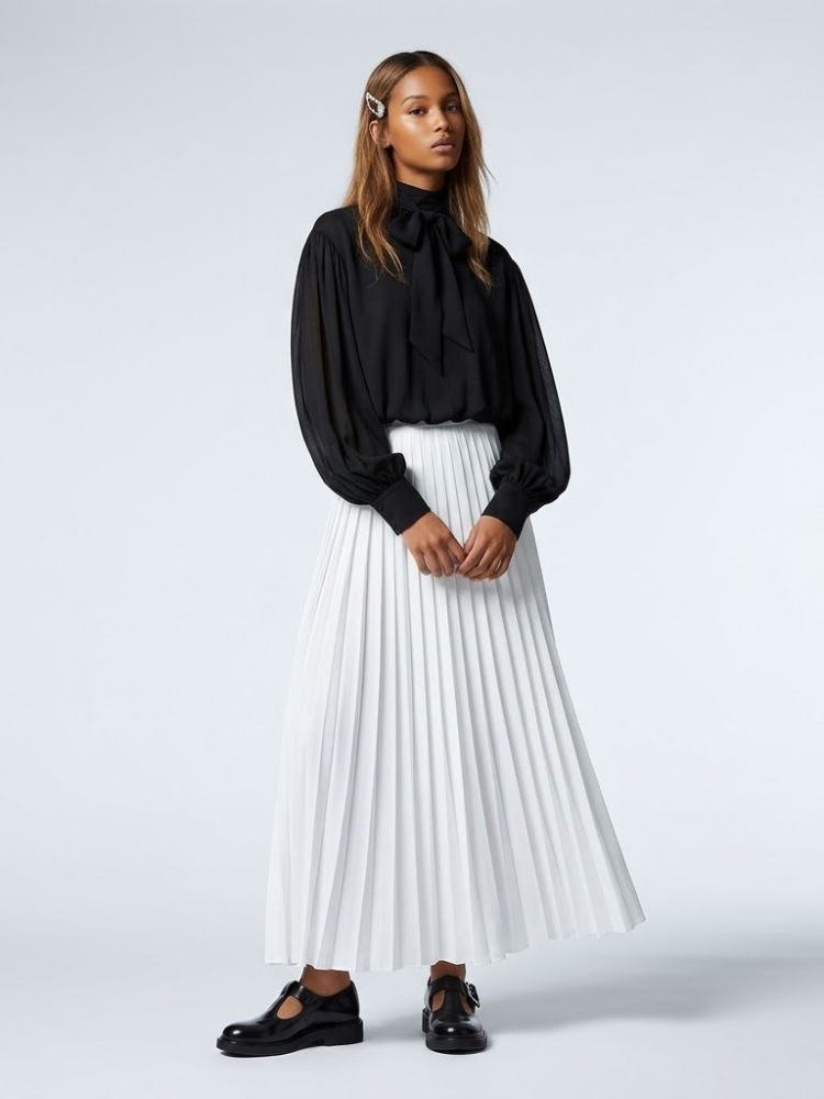 NOLITA women's wrap-inspired blouse featuring a high-neck mock collar and dramatic puff sleeves