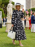 Black and white geometric maxi shirt dress with pointed collar, long sleeves, and matching self-tie belt