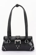 Chelsea metal studded vegan leather shoulder bag with adjustable strap and prominent front buckle.