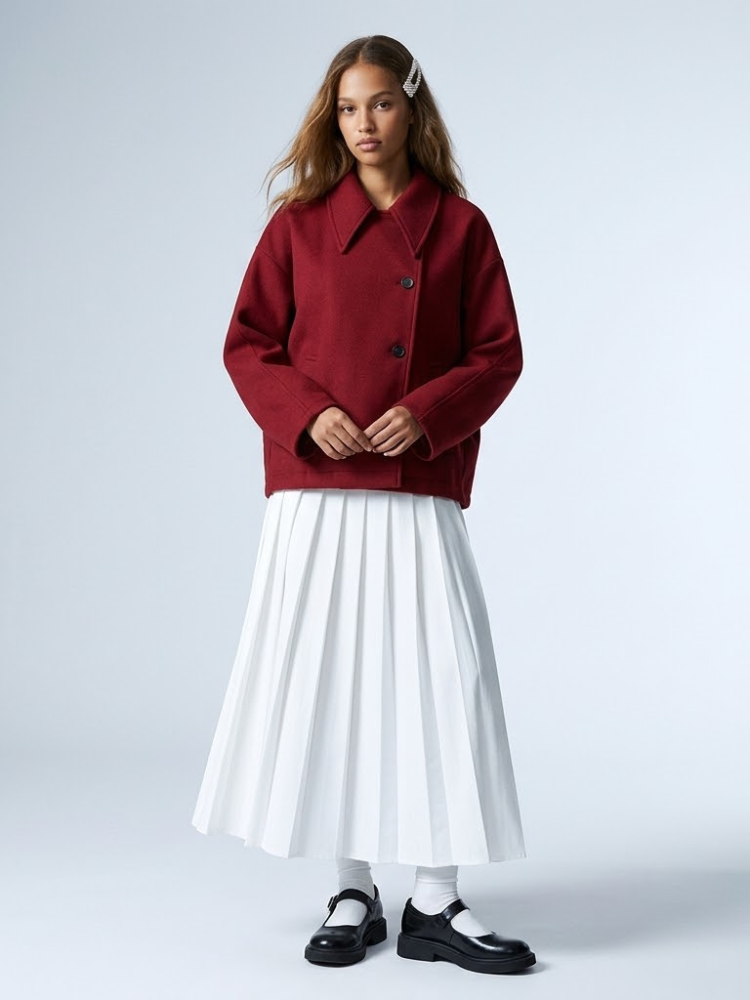 Deep crimson women's jacket with pointed collar, boxy silhouette, and asymmetric button closure