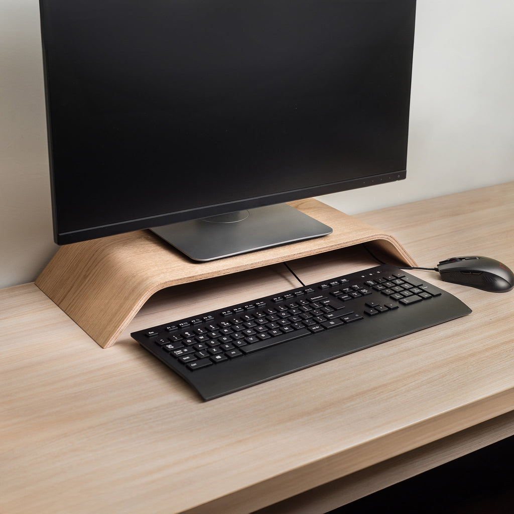 Wooden computer monitor stand riser in a minimalist Scandinavian design for neat office desk organization.