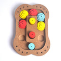 Wooden puzzle toy for dogs featuring treat hiding compartments in paw print and bone shapes