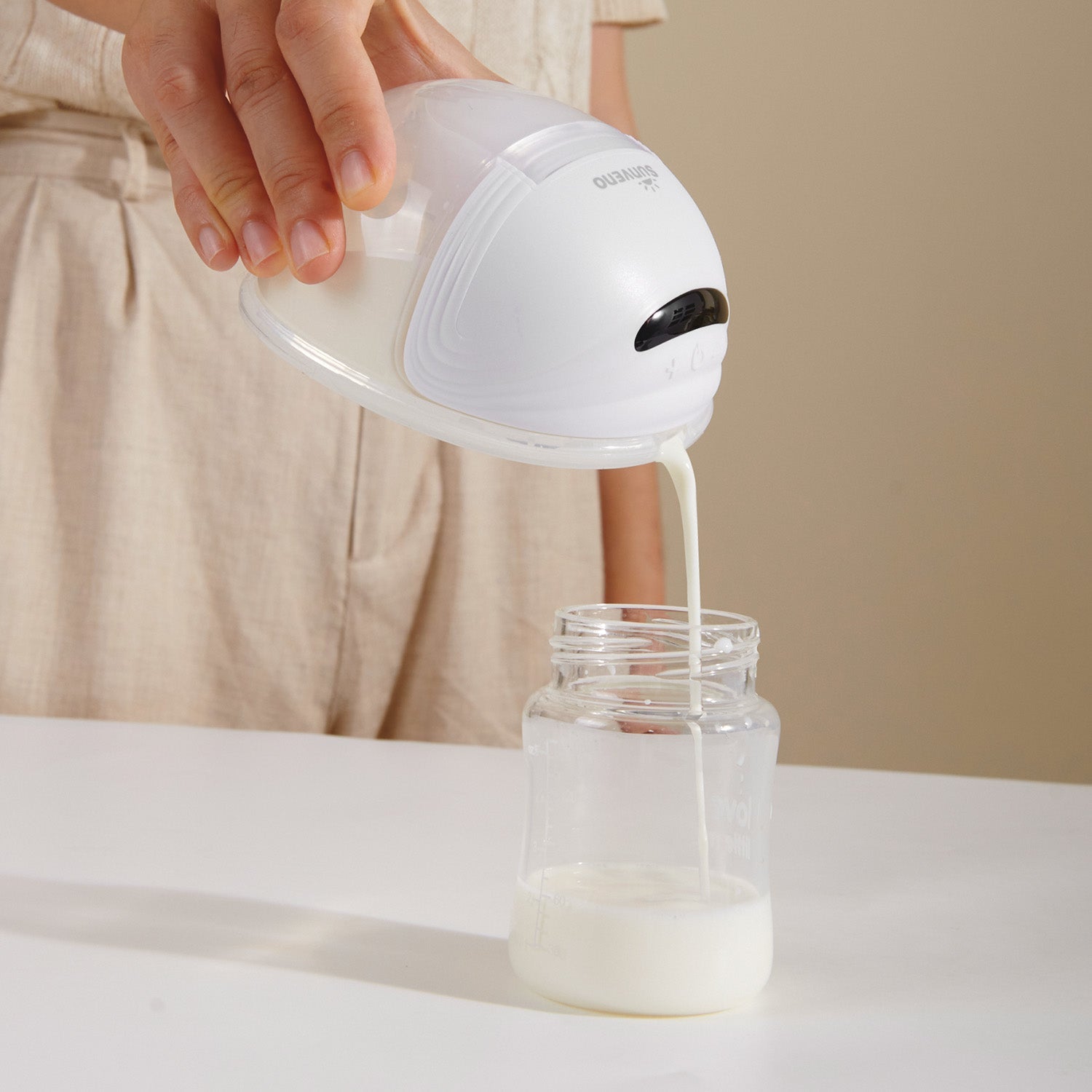 Hands-free wearable electric breast pump with milk collection cups and silicone flanges — view 5