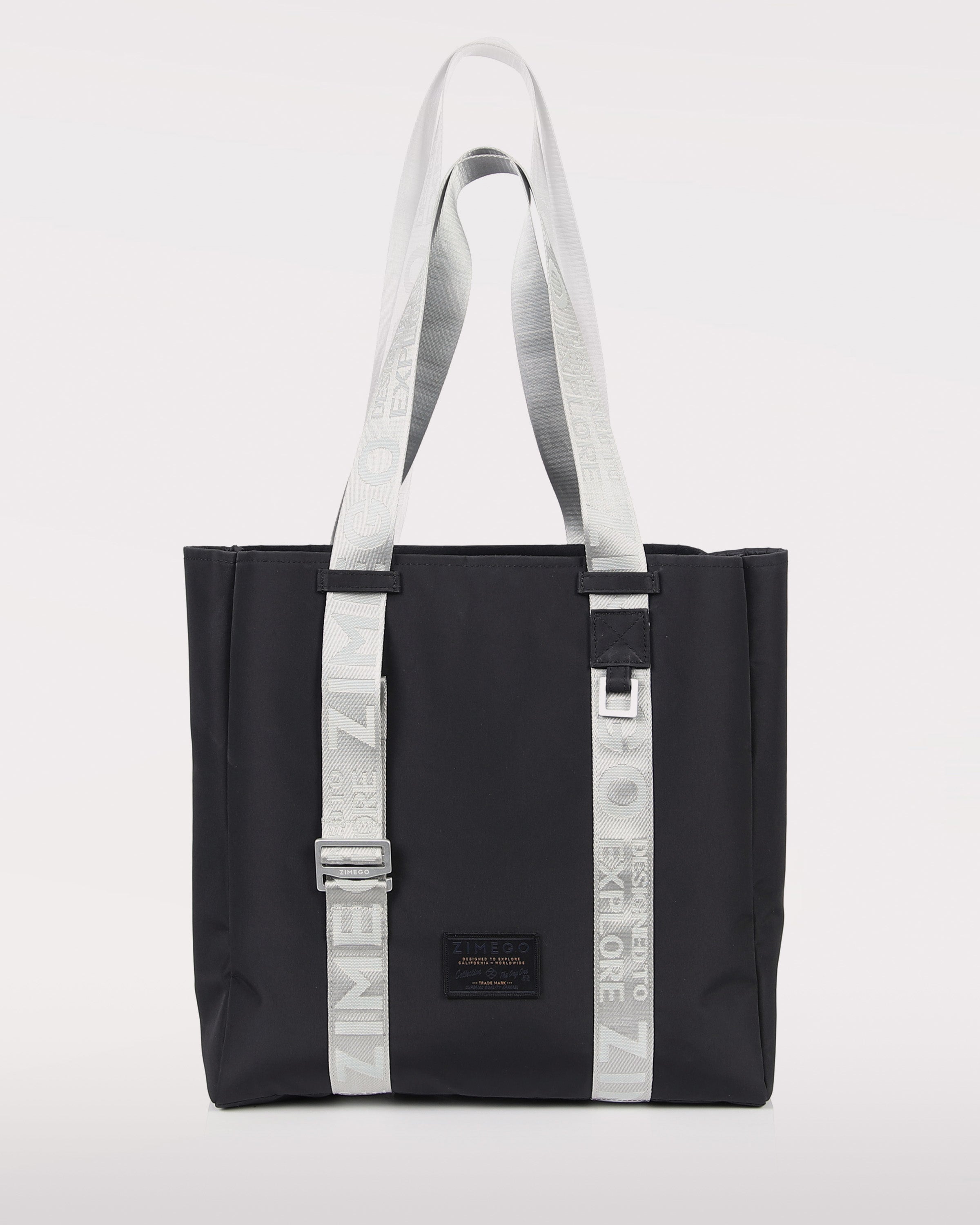 Navy blue nylon laptop tote bag with metallic silver straps and adjustable handles