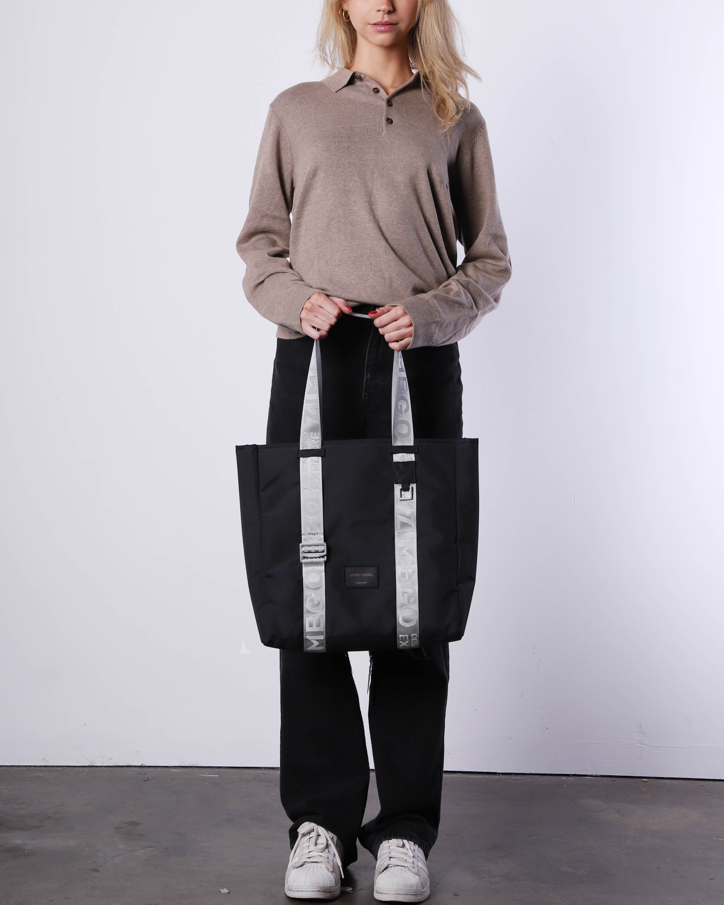 Navy blue nylon laptop tote bag with metallic silver straps and adjustable handles — view 4