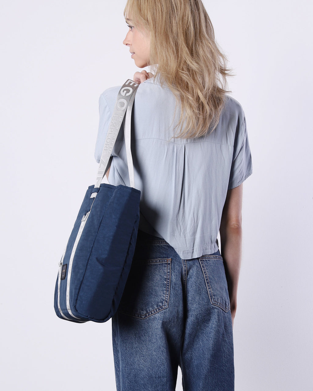 Navy blue nylon unisex laptop tote bag with adjustable metallic straps and padded tech sleeve — view 4