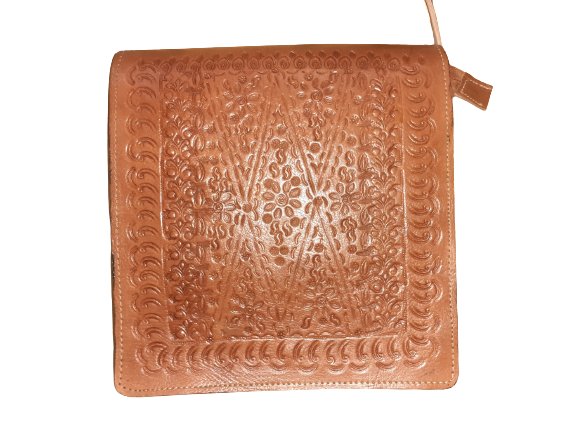 Square rustic cowhide crossbody bag with a carved leather flap and a secure magnetic closure — view 5