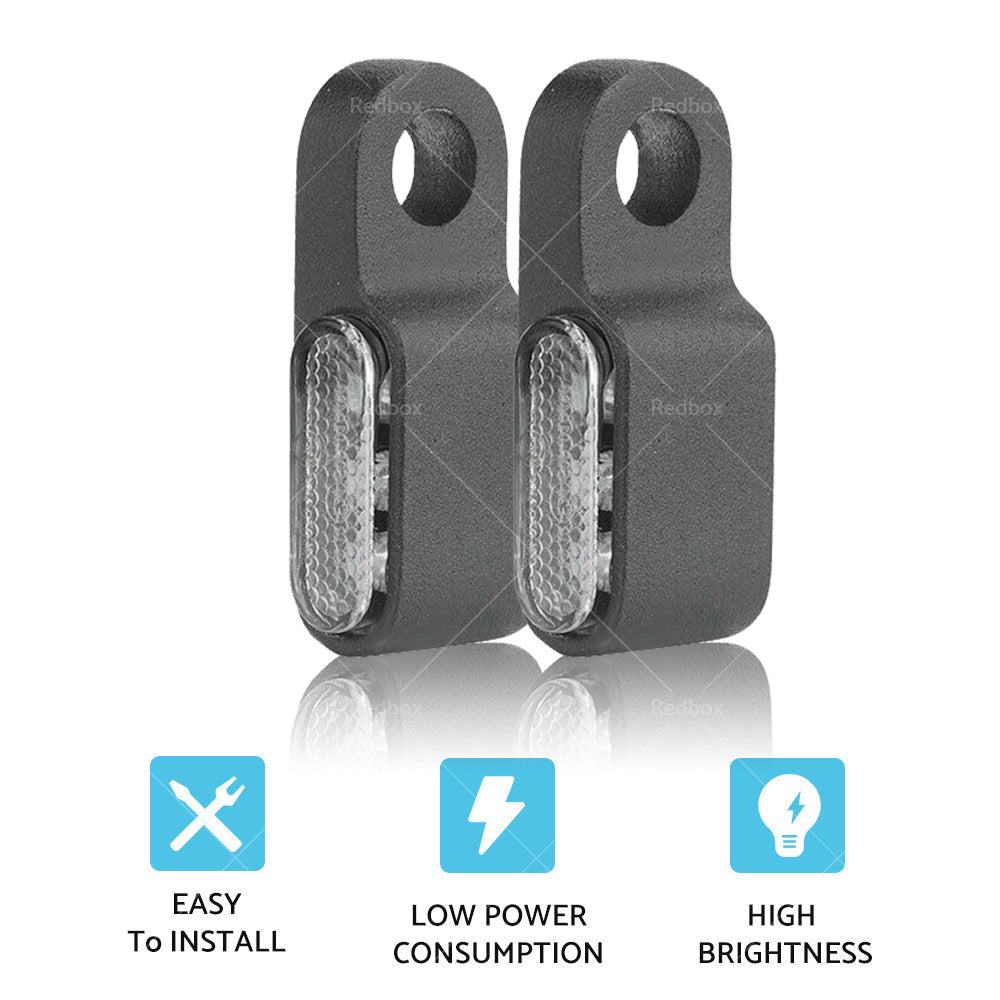 Two black aluminum mini LED motorcycle turn signals emitting bright amber blinker light. — view 5