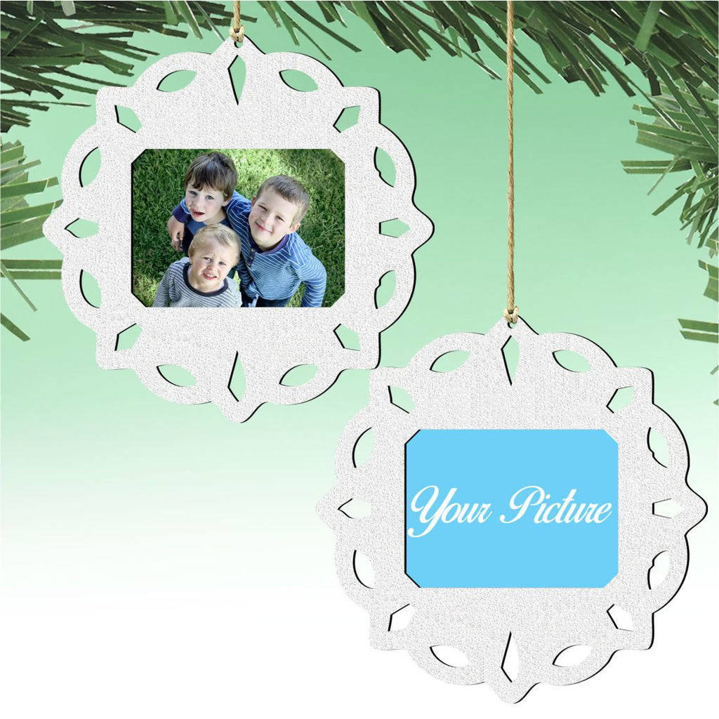 Wooden handcrafted snowflake Christmas tree ornament holding a small rectangular family photograph inside