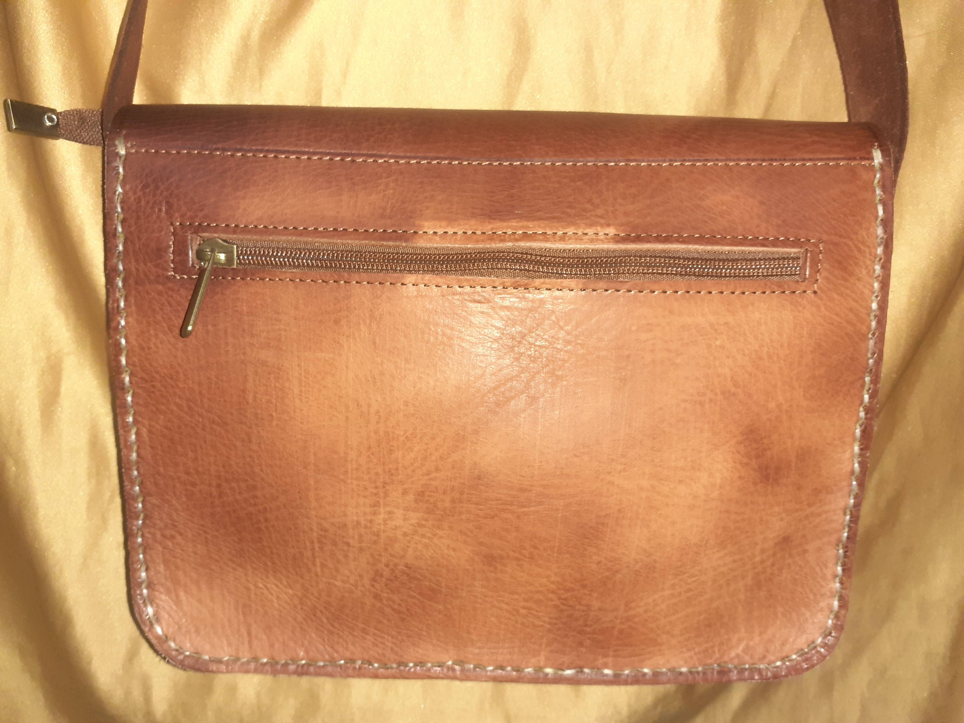 Two-tone leather crossbody bag with rustic finish, front zipper pocket, and long adjustable shoulder strap — view 7