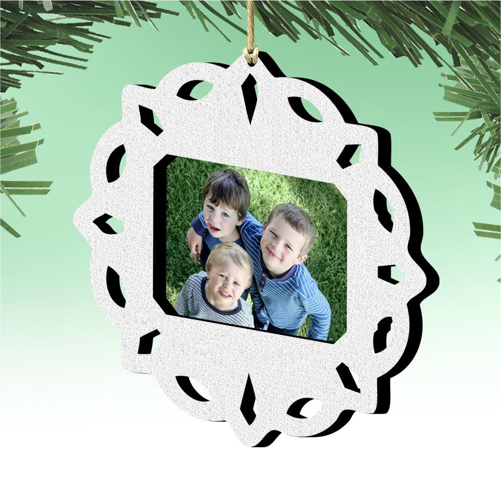Wooden handcrafted snowflake Christmas tree ornament holding a small rectangular family photograph inside — view 2