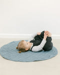 Stone washed linen quilted play mat in a neutral hue with thick, soft cotton filling