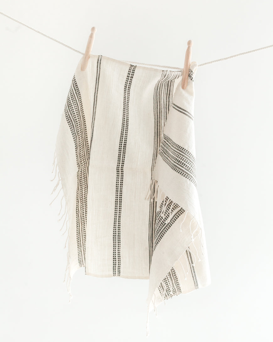 Aden cotton hand towel in a folded stack, showcasing rich hand-spun Ethiopian cotton texture