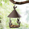 Brown iron aviary bird feeder with decorative artificial birds and delicate floral garden accents