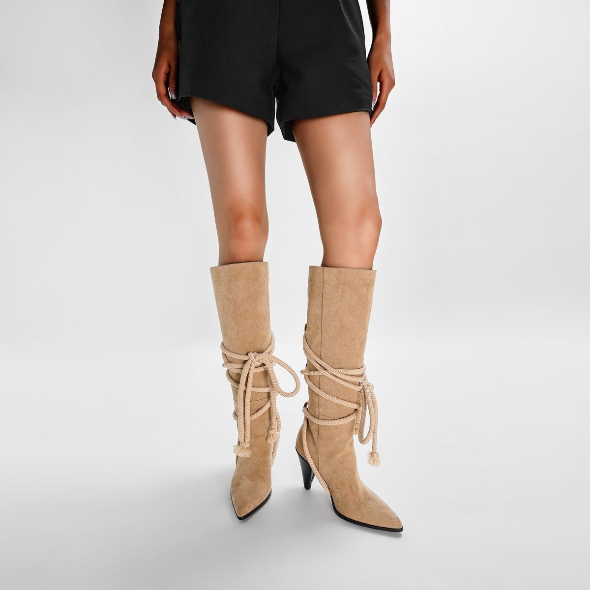 Apricot bohemian knee high boots in soft suede featuring lace-up rope ties and pointed toes