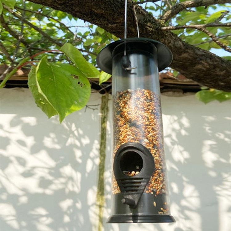 Black metal and transparent plastic automatic hanging bird feeder for outdoor garden spaces. — view 5