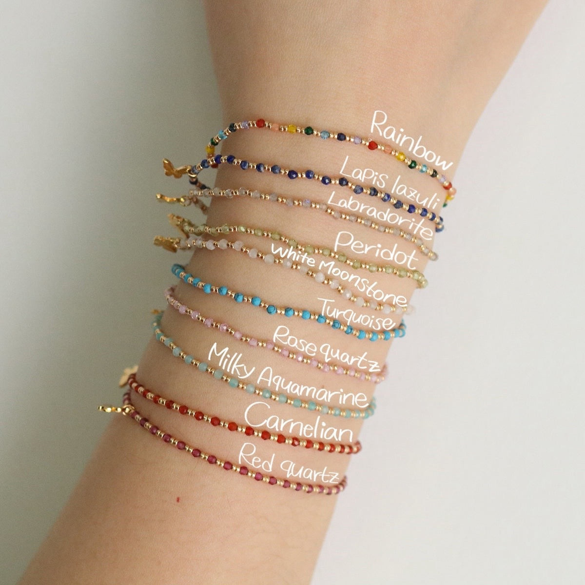 Gemstone butterfly charm stretch bracelet with delicate beads and a miniature metallic butterfly pendant — view 2
