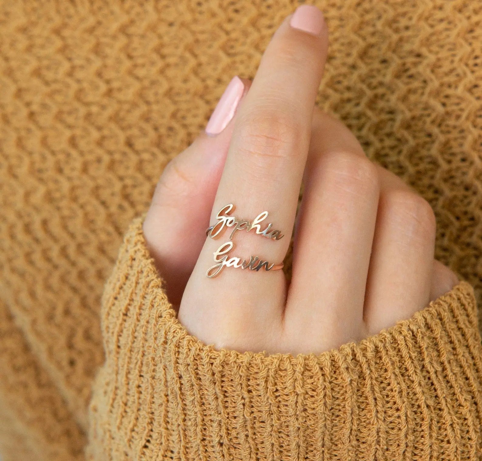 Personalized custom name ring in polished 18k gold featuring delicate cursive typography styling