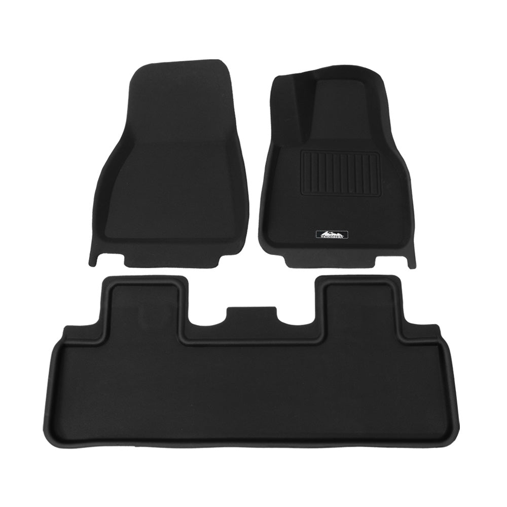 Custom moulded black rubber front and rear floor mats for Tesla Model Y interior protection.